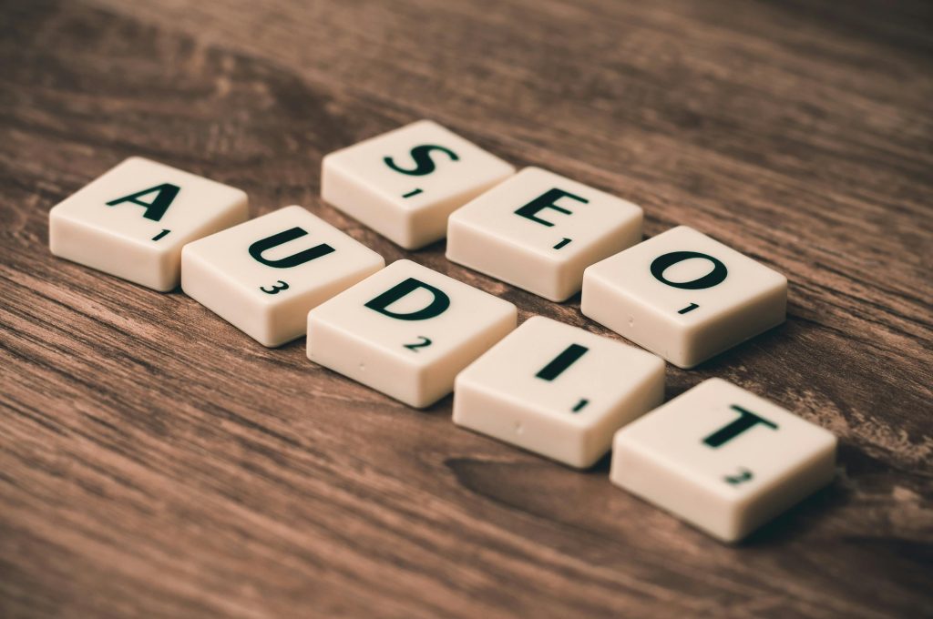 pexels-photo-267415-267415 Scrabble tiles spelling SEO Audit on wooden surface, symbolizing digital marketing strategies.